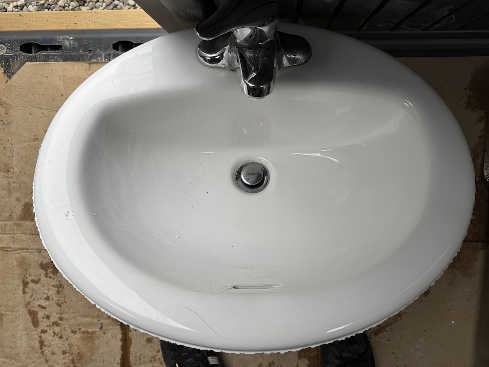 Bathroom sink with faucet and drain